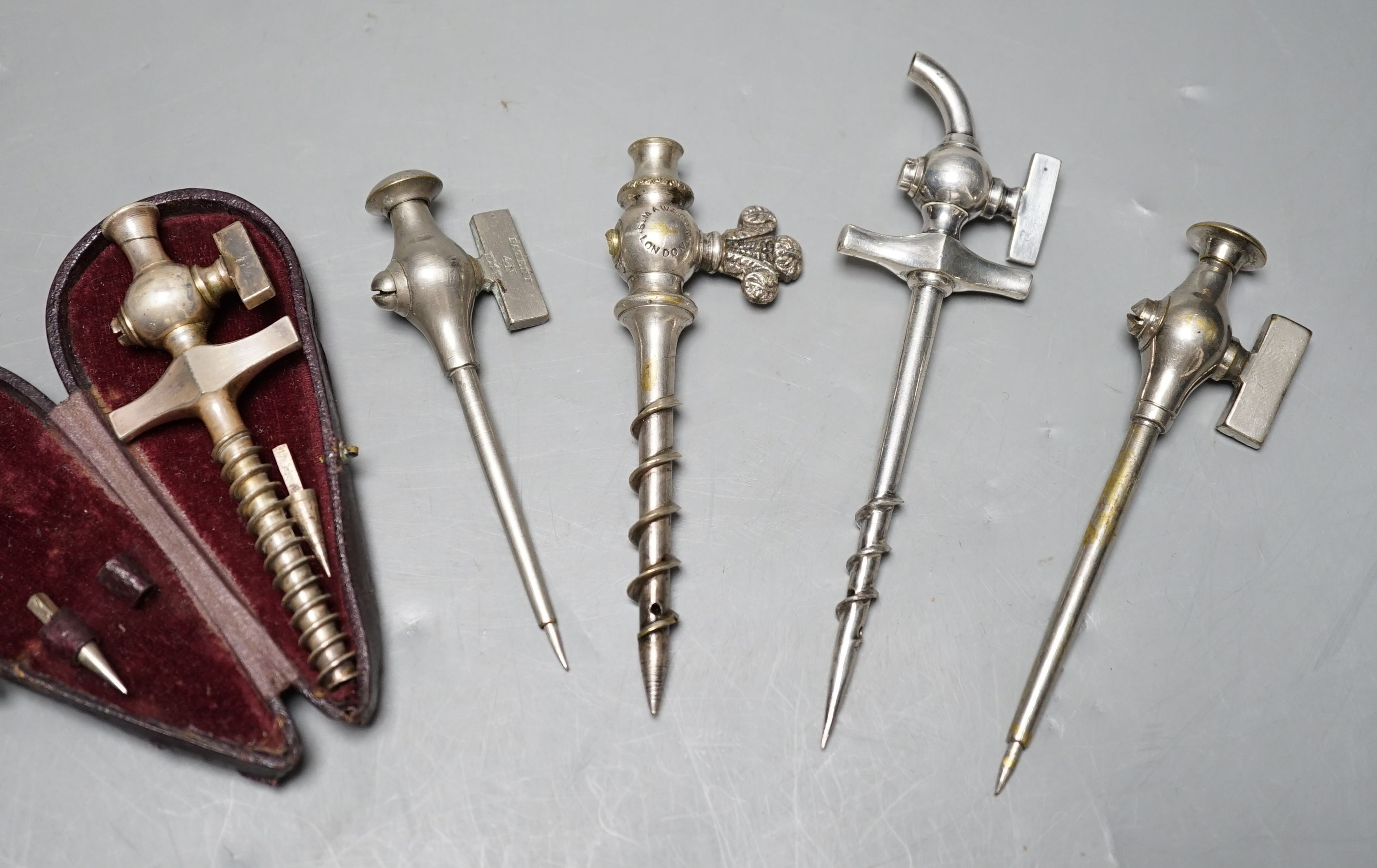 An S. Maw & Son champagne tap and four others, one in original leather case